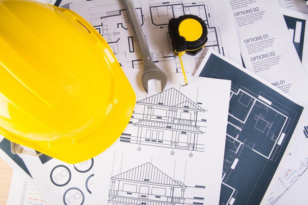 engineer-workplace-with-blueprints-protractor-safety-helmet_1150-2279 engineer-workplace-with-blueprints-protractor-safety-helmet_1150-2279